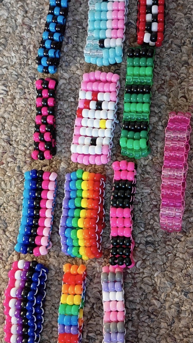 A collection of Laila's handmade kandi cuffs in every color